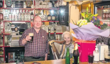  ?? (Pic: George O’Keefe) ?? HERE’S TO NUALA - Ken Butterwort­h behind the bar with proprietor Nuala Fitzgibbon, as the popular hostelry served patrons for the final time on Friday night.