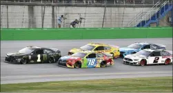  ?? TIMOTHY D. EASLEY — THE ASSOCIATED PRESS ?? Kurt Busch (1) leads Kyle Busch (18), Joey Logano (22), Brad Keselowski (2) and Martin Truex Jr. (19) following a restart during the NASCAR Cup Series auto race at Kentucky Speedway in Sparta, Ky., Saturday.