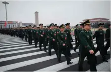  ??  ?? Military delegates arrive for the National People’s Congress in Beijing yesterday. Photo: Nicolas Asfouri/Getty