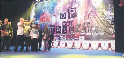  ??  ?? GIMIK RASMI: Adam Yii menyumpit belon sebagai simbolik perasmian konsert amal ‘DP Got Talent’, yang telah berlangsun­g di Dewan Suarah Miri, sambal disaksikan oleh Haslinda (dua kanan) di Miri, malam kelmarin.