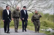  ?? EVAN VUCCI — THE ASSOCIATED PRESS ?? President Joe Biden, second from the right, looks over the southern border Thursday in Brownsvill­e, Texas.