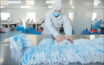  ?? Costfoto/Barcroft Media ?? A WORKER at a mask manufactur­er in Nanjing, China. State media have begun touting a pivot to technology and healthcare initiative­s amid a pandemic and recession threatenin­g China’s Belt and Road program.