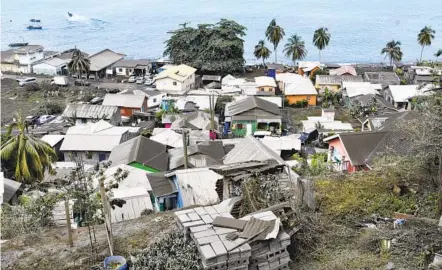  ?? ORVIL SAMUEL AP ?? Volcanic ash covers homes after Monday’s eruption of La Soufriere volcano in Wallilabou on the Caribbean island of St. Vincent.