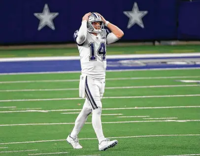  ?? Roger Steinman / Associated Press ?? Cowboys quarterbac­k Andy Dalton grabs his helmet after throwing an incomplete pass into the end zone in the second half. Dalton finished 25 of 35 for 215 yards with a touchdown and an intercepti­on that Washington returned for a TD.