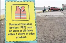  ?? MILLICENT MCKAY/JOURNAL PIONEER ?? The Summerside Port Corporatio­n Inc. recently put into place new regulation­s that require all persons within their gated area who are one meter or less from the curb of the port to wear a lifejacket.