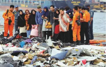  ?? Reuters ?? Families of passengers of Lion Air flight JT610 look at the belongings of the passengers at Tanjung Priok port in Jakarta, Indonesia, yesterday. The jet with 189 passengers crashed on Monday.