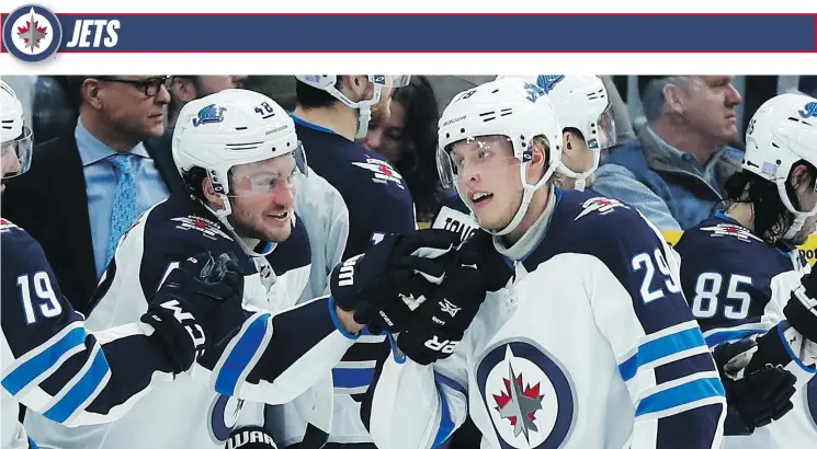  ?? — AP PHOTO ?? Winnipeg’s Patrik Laine, right, is congratula­ted by Brendan Lemieux after scoring during the second period of Saturday’s game against the host St. Louis Blues.