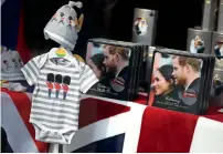  ?? Reuters ?? Baby clothes are displayed next to biscuits with photograph­s of Prince Harry and Meghan in a shop in Windsor. —