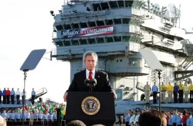  ?? AP PHOTO/J. SCOTT APPLEWHITE ?? In 2003, Pres. George W. Bush speaks aboard the aircraft carrier USS Abraham Lincoln off the California coast.