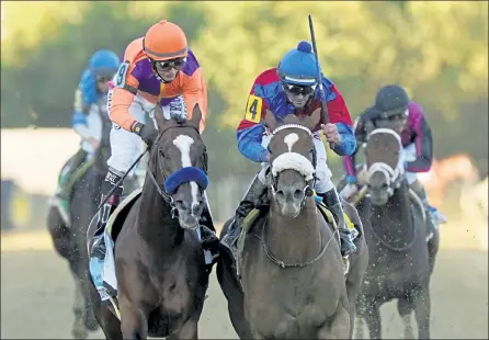  ?? AP ?? Swiss Skydiver, right, ridden by Robby Albarado, wins the 145th Preakness Stakes ahead of Authentic, left, ridden by John Velazquez, at Pimlico Race Course on Saturday.