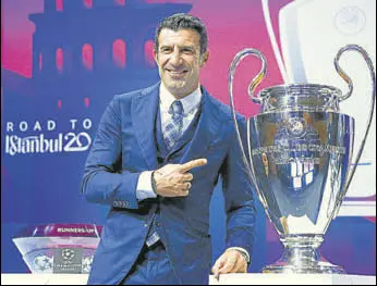  ?? REUTERS ?? Luis Figo poses with the Champions League trophy before the R16 draw in Nyon, Switzerlan­d.