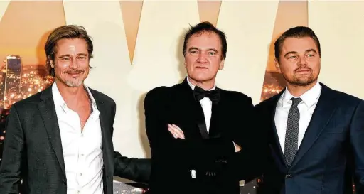  ?? Kevin Winter / Tribune News Service ?? Quentin Tarantino, center, has tweaked his film “Once Upon A Time ... In Hollywood,” starring Brad Pitt, left, and Leonardo DiCaprio, for a novel.