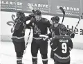  ?? MATT KARTOZIAN/USA TODAY SPORTS ?? The Coyotes celebrate Christian Dvorak’s game-winning goal against the Ducks on Thursday.