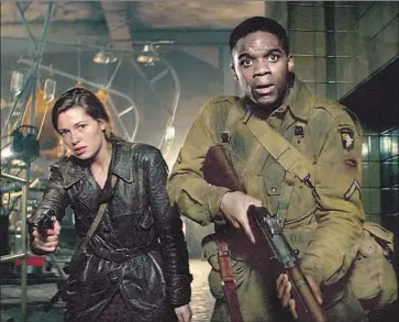  ?? Photograph­s by Peter Mountain Paramount Pictures ?? CHLOE (Mathilde Ollivier) and Boyce (Jovan Adepo) do their part to assist the Allies’ invasion of Normandy.