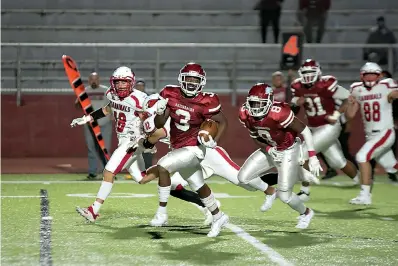  ?? Staff photo by Kelsi Brinkmeyer ?? ■ Arkansas High running back Torie Blair heads for a touchdown, putting the Razorbacks in the lead during the final seconds of their game against Camden Fairview on Friday in Texarkana. The Hogs won, 28-21.