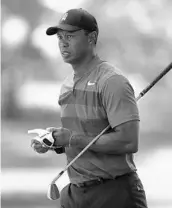  ?? JASON E. MICZEK/ASSOCIATED PRESS ?? Tiger Woods, who posted a par 71 in the opening round in Charlotte, walks down the second fairway on Thursday.