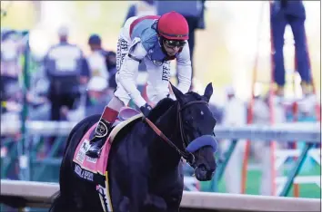  ?? Michael Conroy / Associated Press ?? John Velazquez rides Medina Spirit to victory in the 147th running of the Kentucky Derby on Saturday.