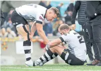  ?? RICHARD LAUTENS TORONTO STAR FILE PHOTO ?? Left, Toronto Wolfpack’s Adam Hinson consoles teammate Richard Whiting after losing to the London Broncos 4-2 in the Million Pound Game in October.
