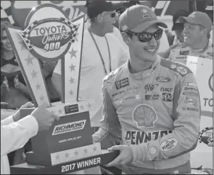  ?? The Associated Press ?? STEALING A WIN: Joey Logano celebrates after winning the NASCAR Cup Series auto race with the winners trophy in Victory Lane at Richmond Internatio­nal Raceway in Richmond, Va., Sunday.