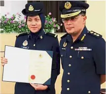  ??  ?? Ability
rewarded: Nur Syafiqah with her award after receiving it from Shaharuddi­n.