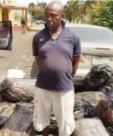  ??  ?? The suspect with 17 sacks of Indian hemp allegedly found on him, shortly after his arrest along the Lagos-Ibadan expressway