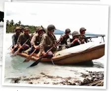  ??  ?? Right: Marine Raiders posing in a rubber boat. Note the Marine sitting in the bow is holding a .30cal Browning Automatic Machine gun (US National archives)