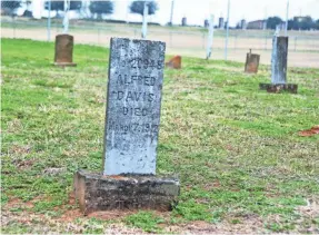  ??  ?? A tombstone marks the grave of a prisoner buried in the Old Imperial Farm Cemetery, a half-mile from where the remains of 95 African-Americans were found.