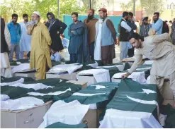  ??  ?? QUETTA: Pakistani mourners gather around the coffins of some of those killed in an attack on the Police Training College Balochista­n in Quetta yesterday. — AFP