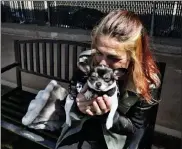  ?? Ap ?? rachel niebur kisses her dog, petey, at a small dog park with the nonprofit people assisting the Homeless on april 5. Being homeless in los angeles and struggling with addiction is hard enough, but niebur couldn't imagine enduring it without her dog. niebur credits her constant companion, a black and white chihuahua mix, with helping to keep her off drugs and giving her a reason to get up in the morning.