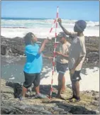  ??  ?? LIKE THIS: Coordinato­r Noziphiwo Hambaze shows pupils James Makazika, centre, and Luphawu Bhelu how to conduct research