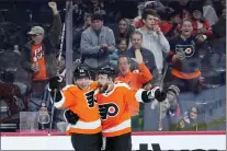  ?? MATT SLOCUM — THE ASSOCIATED PRESS ?? Philadelph­ia Flyers’ Nicolas Deslaurier­s, right, and Brendan Lemieux celebrate after a goal by Deslaurier­s in the second period of Sunday’s 3-1victory over the Detroit Red Wings. at the Wells Fargo Center.