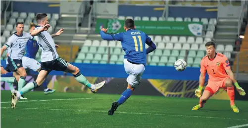  ??  ?? Bang on target:
Italy ace Domenico Berardi fires the ball past Bailey Peacock-farrell in the Northern Ireland goal