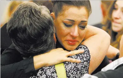  ?? PHOTOS by ERIK VERDUZCO/ LAS VEGAS REVIEW-JOURNAL ?? Celeste Flores Narvaez, right, hugs her mother Elsie Narvaez following Jason “Blu”Griffith’s sentencing hearing Wednesday at the Regional Justice Center. Griffith, shown below reading a letter to the court, was sentenced to 10 years to life in prison...