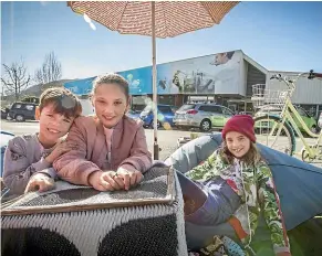  ??  ?? Siblings Raphael, Sofia and Anouk Rainieri enjoy the sun with other classic bicycle enthusiast­s in Nelson on Saturday.