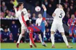  ?? ?? LONDON: Crystal Palace’s Zaire-born Belgian striker Christian Benteke vies with Leeds United’s Spanish defender Diego Llorente and Leeds United’s German defender Robin Koch during their English Premier League match at Selhurst Park on April 25, 2022. —AFP