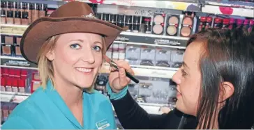  ?? Photo: DIANE BISHOP/
FAIRFAX NZ ?? Country music fan:Gore Gold Guitar Young Ambassador Shanna Forbes gets her makeup done byQuins Unichem Pharmacy dispensary technician KaylaMacka­y.