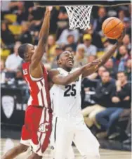  ?? David Zalubowski, The Associated Press ?? Colorado guard McKinley Wright IV drives for a basket past Washington State guard Viont’e Daniels on Thursday night.