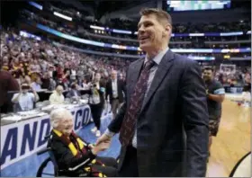  ?? TONY GUTIERREZ - THE ASSOCIATED PRESS ?? Sister Jean Dolores Schmidt, left, greets Loyola-Chicago coach Porter Moser after the team’s 63-62 win over Tennessee in a second-round game at the NCAA men’s college basketball tournament in Dallas, last Saturday.