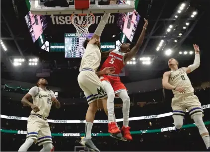  ?? Sacramento BEE/TNS ?? Milwaukee Bucks’ Brook Lopez blocks a shot by Sacramento Kings’ De’aaron Fox during the first half of a game Monday in Milwaukee.