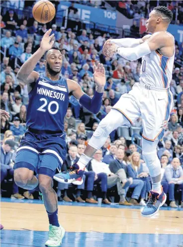  ?? [PHOTO BY SARAH PHIPPS, THE OKLAHOMAN] ?? Oklahoma City’s Russell Westbrook passes the ball as Minnesota’s Josh Okogie defends during Tuesday’s game at the Chesapeake Energy Arena.