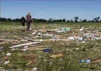  ?? SARAH A. MILLER, THE ASSOCIATED PRESS ?? Kyle Allen walks his parents’ property in Canton, Texas, on Sunday, looking for personal items. Severe storms including tornadoes swept through several small towns in the U.S. Midwest and south Saturday and Sunday.