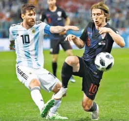  ?? AP ?? When the Croats took Argentina by the throat: Messi was offcolour again as Croatia ran circles around Argentina. Croatian star Luka Modric, vying for the ball with Messi here, came up with a superb goal as his team won 30.