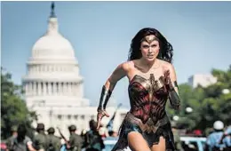  ?? CLAY ENOS/WARNER BROS. PICTURES ?? Gal Gadot in a scene from “Wonder Woman 1984.” Warner Bros. will hold a 24-hour virtual event in August featuring the biggest heroes in the DC Comics universe.