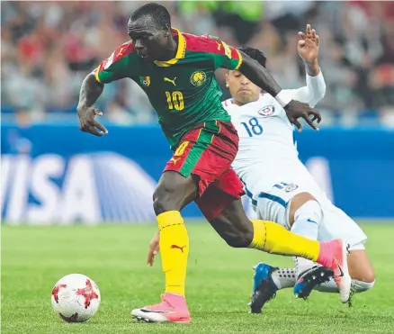  ?? ON ATTACK: Cameroon's forward Vincent Aboubakar advances with the ball past Chilean defender Gonzalo Jara. ??