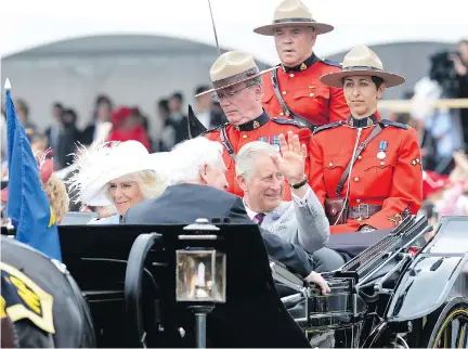  ?? ADRIAN WYLD/THE CANADIAN PRESS ?? A carriage carries Camilla, Duchess of Cornwall and Prince Charles during Saturday’s celebratio­ns.