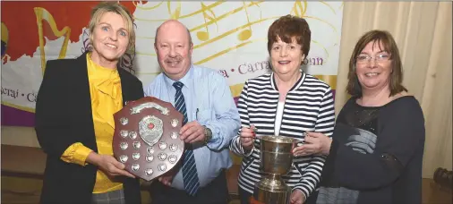  ??  ?? Marie Casey(Boherbue) accepts the Best Scor na bPaistí Shield from Tony McAulliffe, Chairman, Cork Scór and Margaret Kiely(Boherbue) receives the Padraig O Cearbhaill Cup from Margaret Whelan, Secretary, Cork Scor that recognises Boherbue as Best Scór...