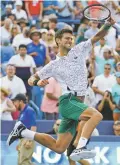  ?? JOHN MINCHILLO/ASSOCIATED PRESS ?? Novak Djokovic reacts after defeating Roger Federer during the finals of the Western &amp; Southern Open on Sunday in Mason, Ohio.