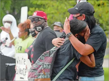  ?? SARAH GORDON/THE DAY ?? Dena Avery, right, hugs Marchell Alston as she cries during a rally for Chrystal Caldwell at the Stonington Police Department on Monday. Organized by members of New London’s We Won’t Back Down, BLM 860 and other activist groups, the event called for answers and arrests concerning the assault on Caldwell while she was working at the Quality Inn in Mystic over the weekend.