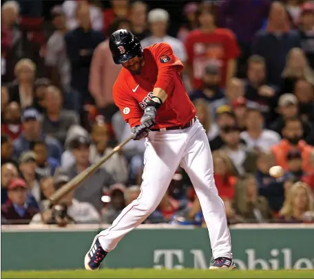  ?? STUART CAHILL / HERALD STAFF ?? SWEET STROKE: J.D. Martinez swings at his game-winning RBI single in the Red Sox’ 2-1 win over the Royals Friday.