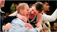  ?? AP PHOTO BY JULIE JACOBSON ?? Michigan head coach John Beilein, left, celebrates with Michigan forward Moritz Wagner (13) after Michigan defeated Purdue 75-66 to win the NCAA Big Ten Conference tournament championsh­ip college basketball game, Sunday in New York.